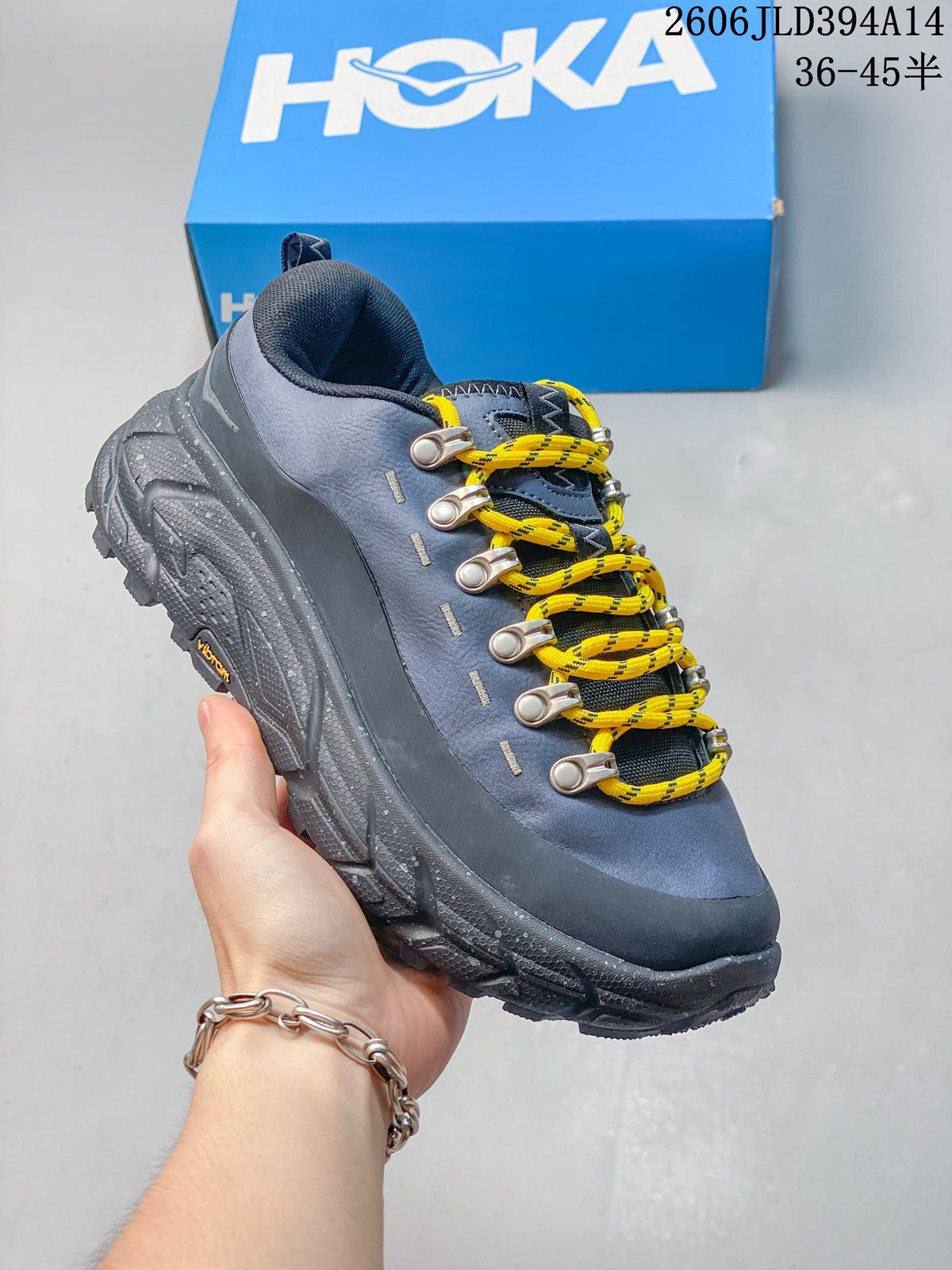 Angled view of a blue-gray shoe with yellow laces and a treaded outsole.