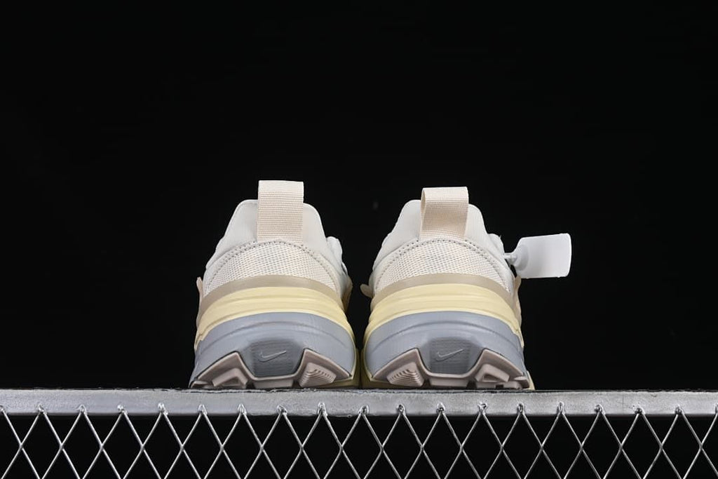 Rear view of both sneakers showing heel pull tabs and layered soles