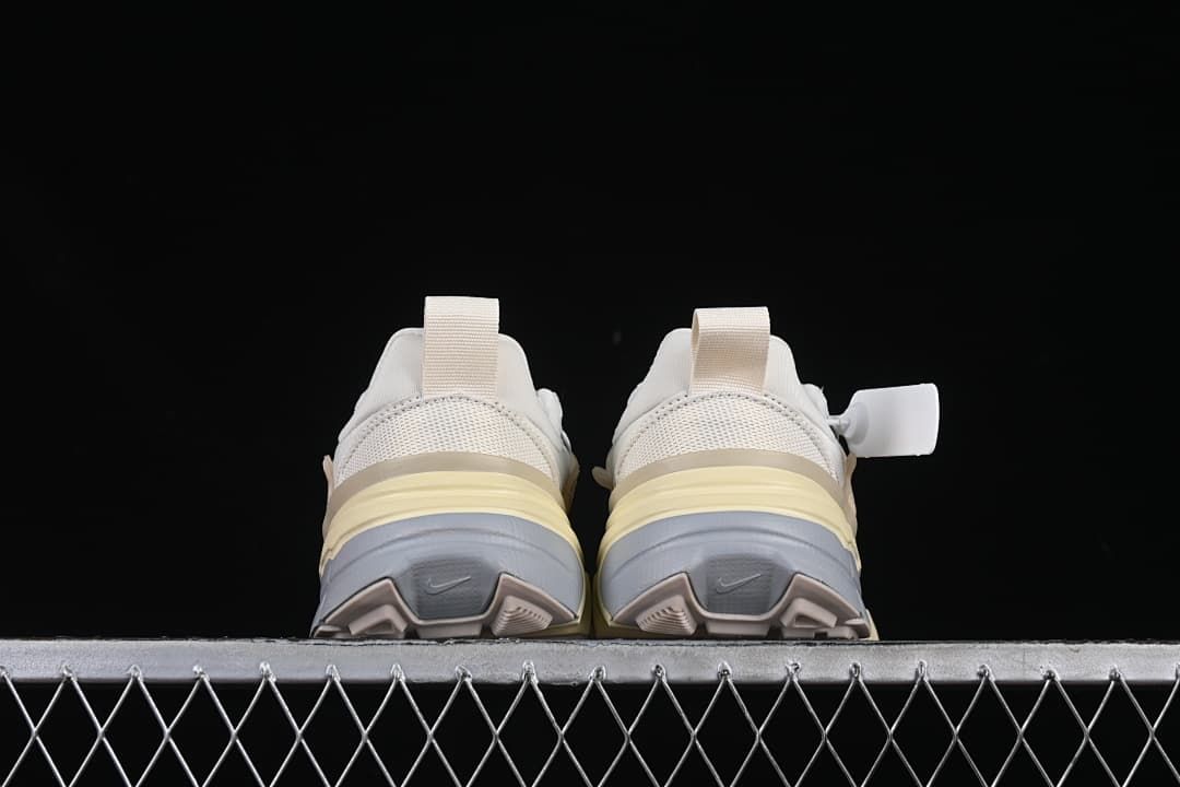 Rear view of both sneakers showing heel pull tabs and layered soles