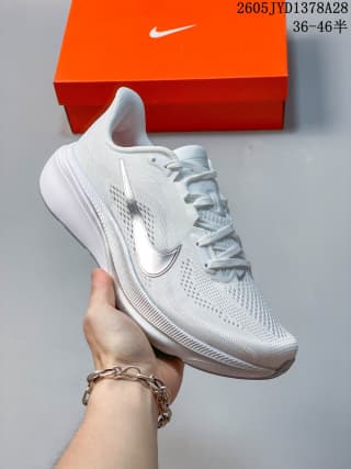 Side view of a white and light gray Nike Air Zoom Pegasus 42 shoe.