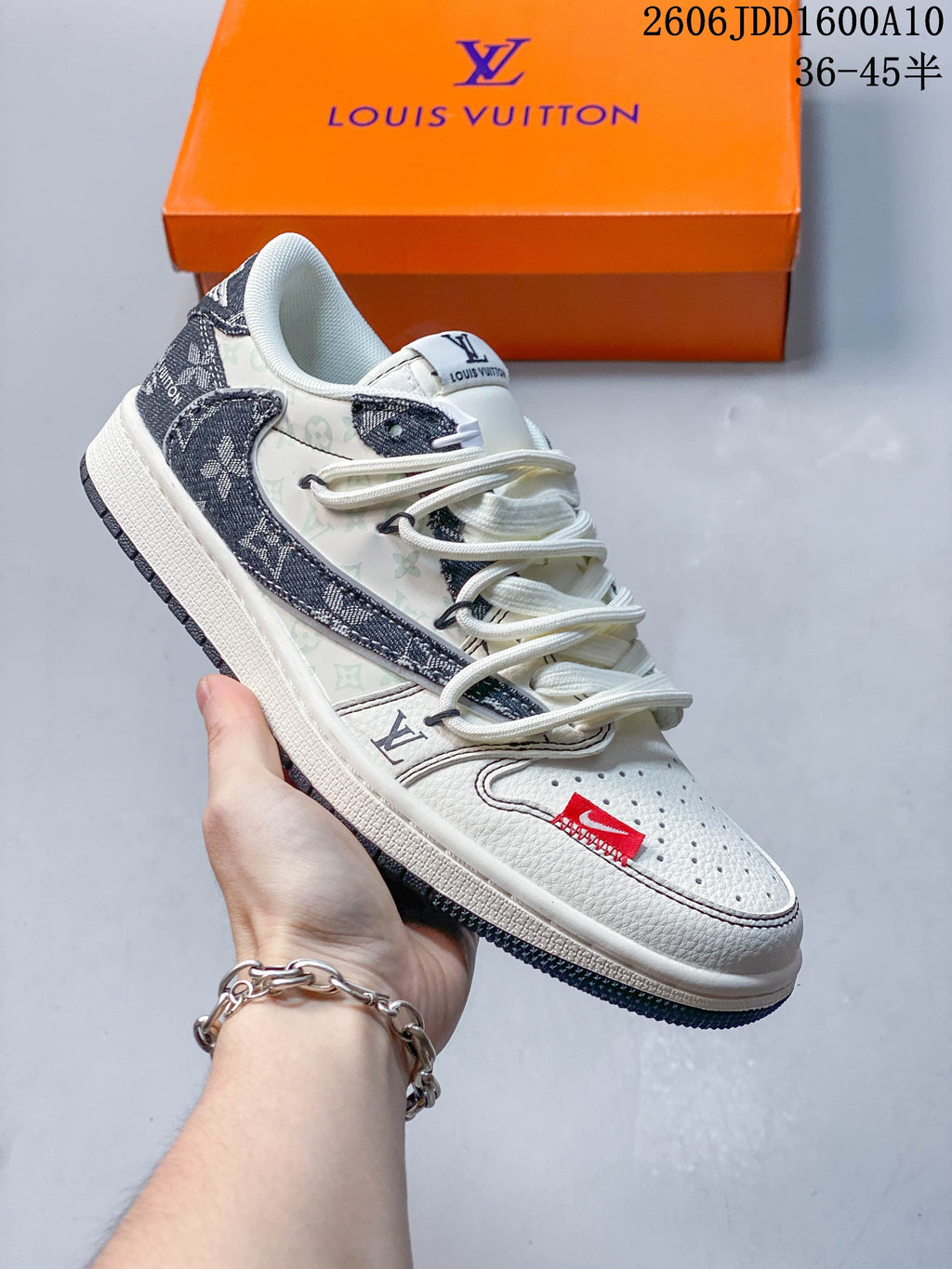 Angled side view showing off-white panels, dark patterned overlays, large swoosh, and red toe accent