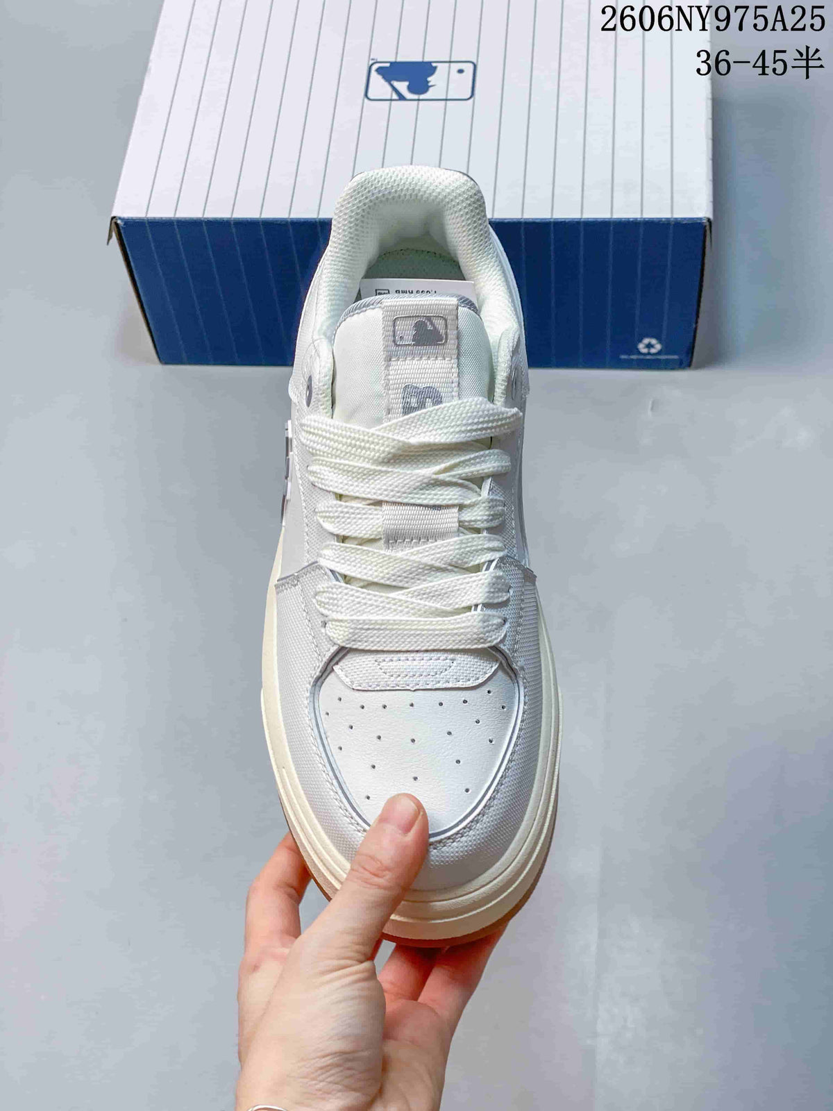 Front view highlighting the white laces, perforated toe panel, and layered construction.