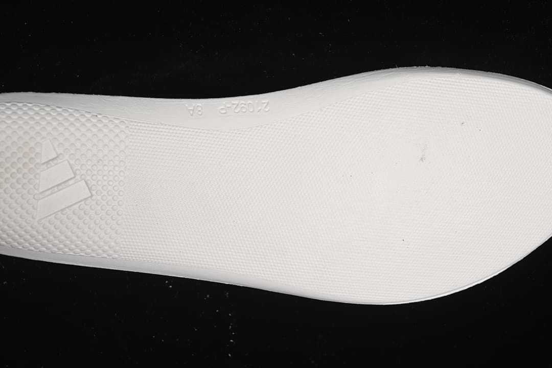 Close-up of the patterned outsole and Adidas logo