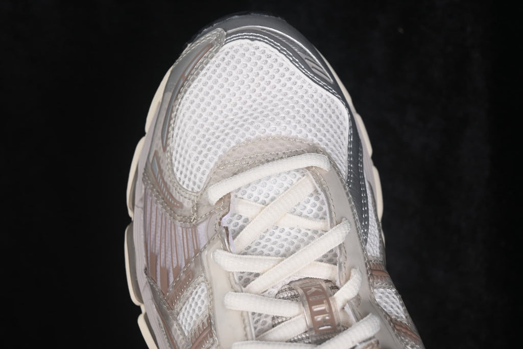 Close-up of the toe box and lacing system with mesh construction and reflective-looking overlay details.