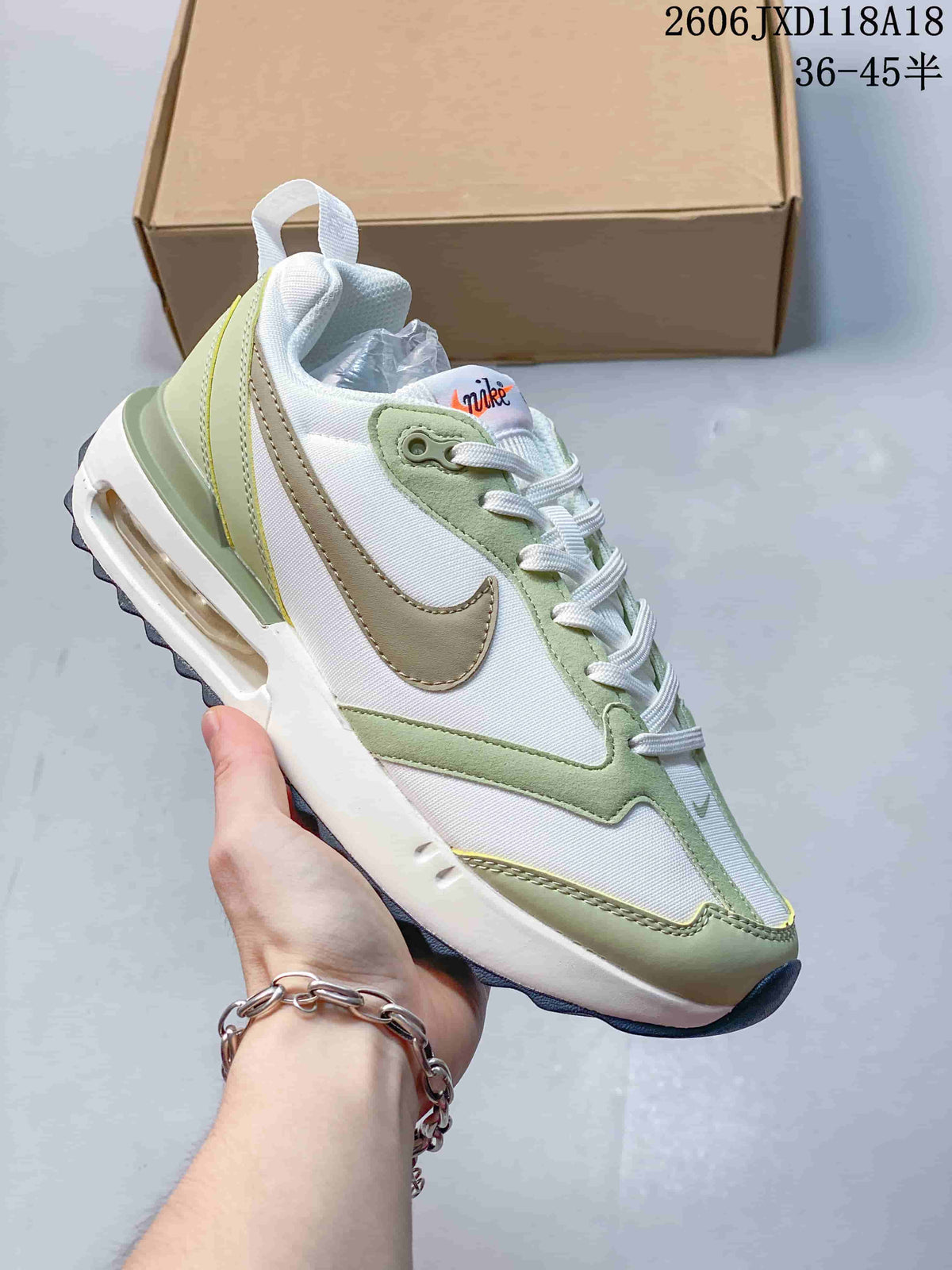 White Nike Air Max Dawn sneaker with pale green and beige accents