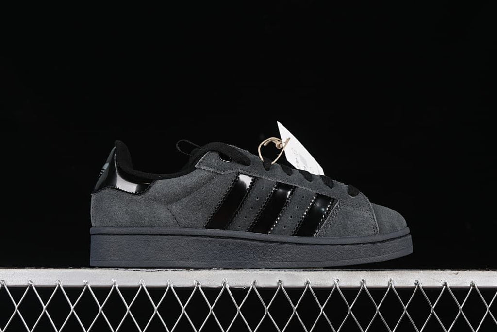 Side profile of the charcoal gray sneaker with black stripes