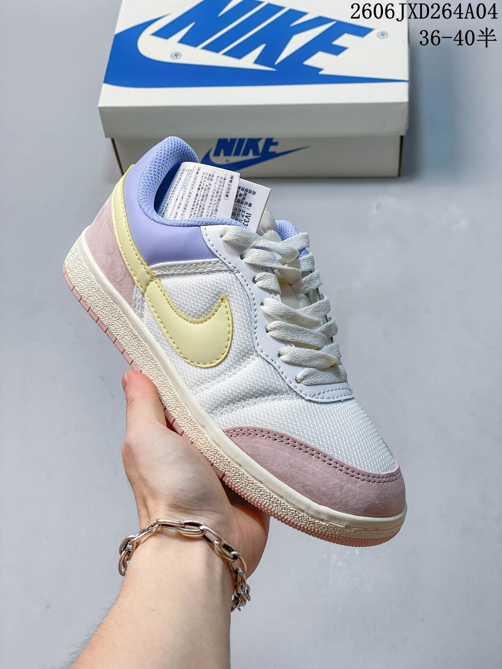 White low-top sneaker with pastel yellow, lavender, and pink accents