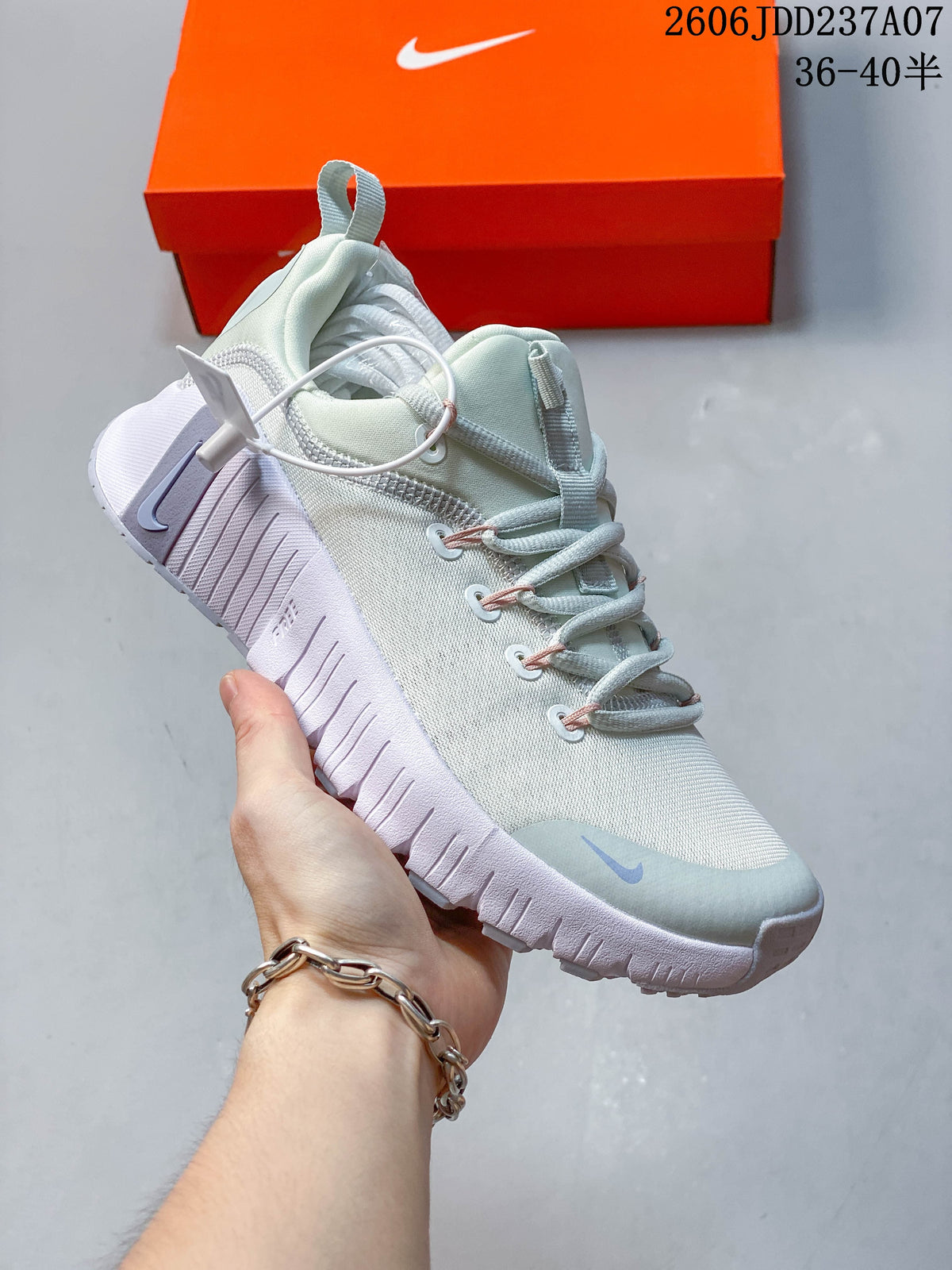 Angled side view of a pale mint Nike Free Metcon 6 shoe with a textured sole