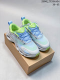 Pair of light blue, pale green, and white On Cloudtilt-style sneakers with elastic lacing, shown on a box.