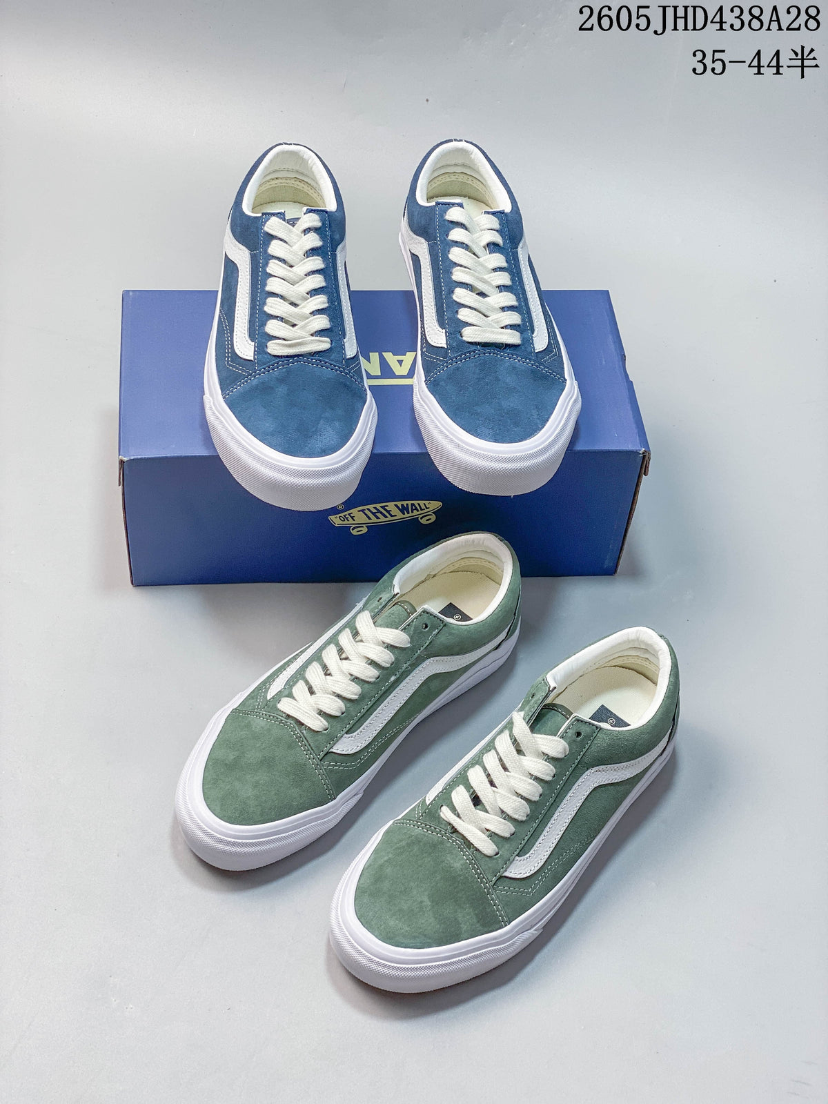 Blue and green low-top sneakers arranged around a blue shoe box.