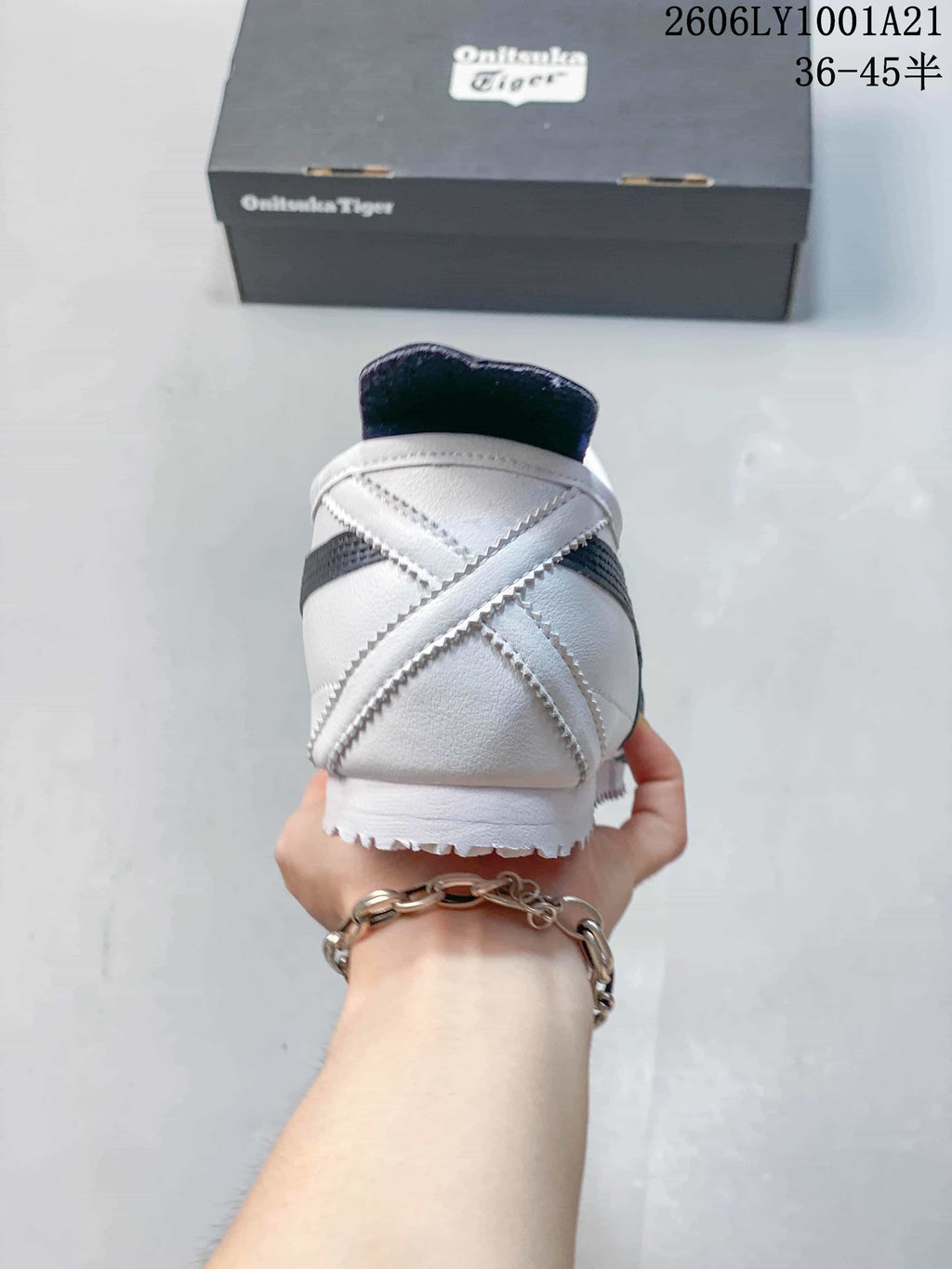 Rear view showing the heel construction of a white and navy Onitsuka Tiger sneaker