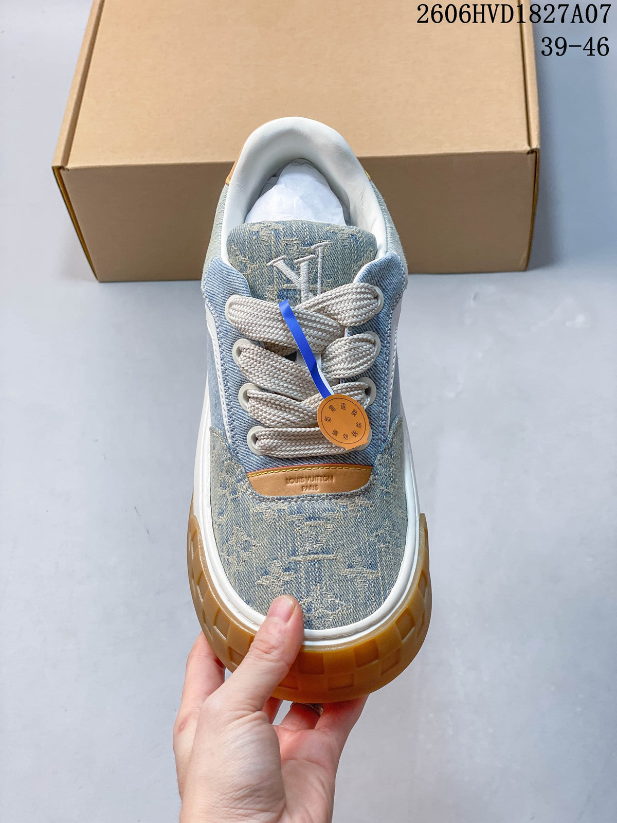 Top view of the sneaker showing cream laces, patterned denim-style panels, and tongue branding.