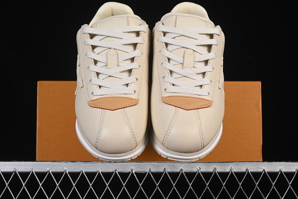Front view of the pair with beige uppers and tan toe accents