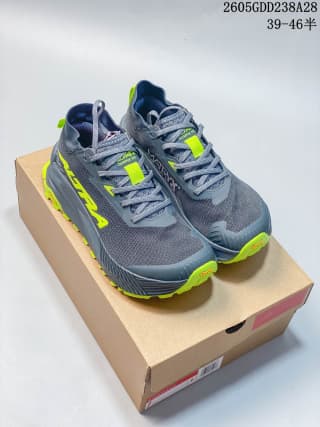 Pair of gray and neon yellow-green trail running shoes on a box