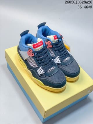 Pair of navy-blue and yellow mid-top sneakers displayed on a box