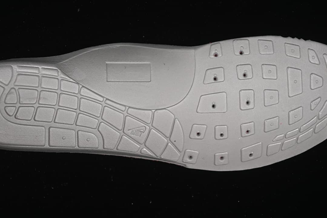 Close-up of the light-colored outsole showing its tread pattern