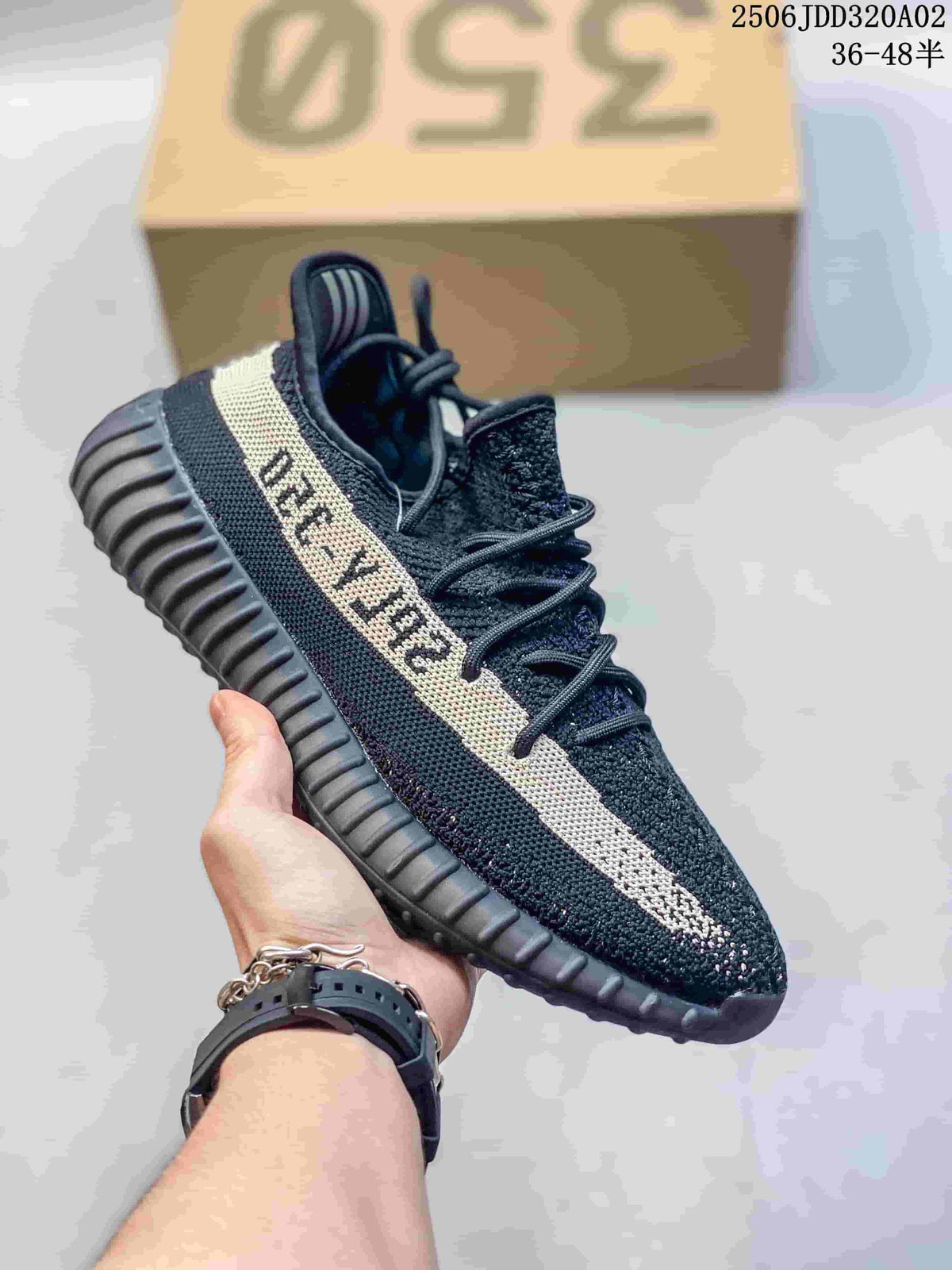Black knit-look sneaker with a cream side stripe and ribbed dark sole