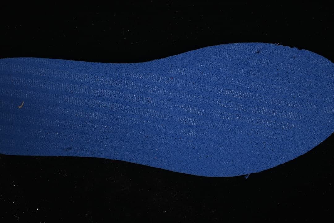 Blue shoe insert displayed against a dark background