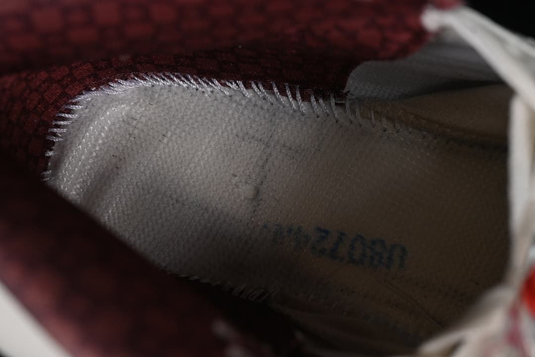Close-up of the shoe interior and burgundy patterned lining