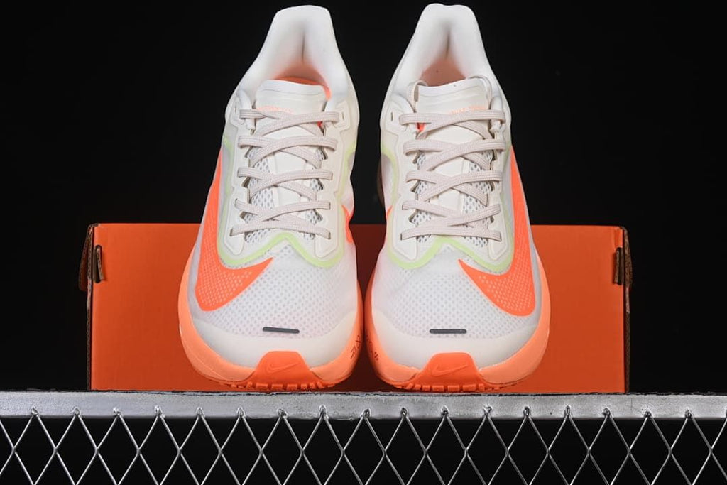 Front view of the pair showing mesh toes and bright orange accents.