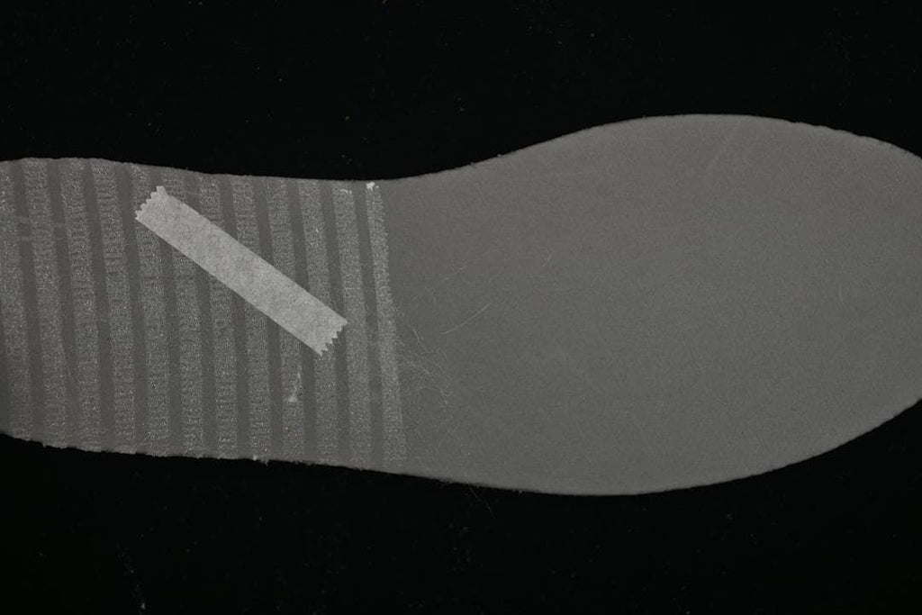 Underside view of the grey sneaker outsole