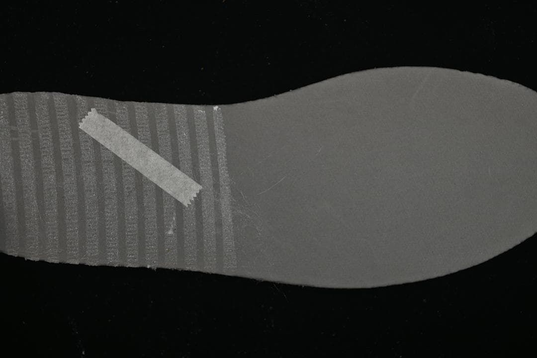 Underside view of the grey sneaker outsole