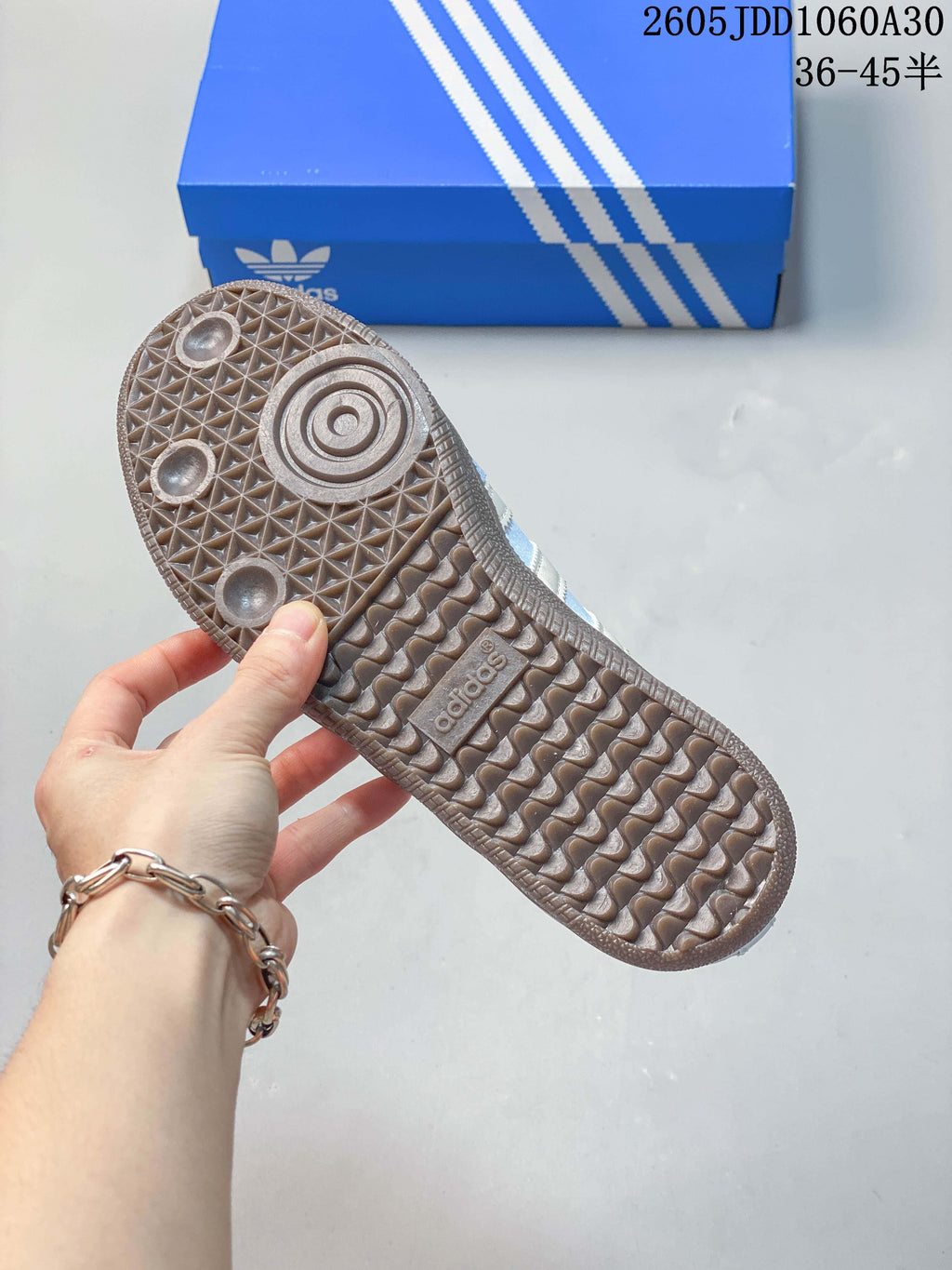 Underside of a sneaker showing a brown patterned outsole