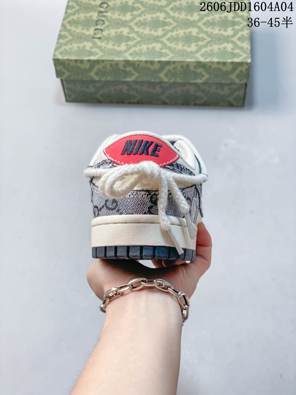Rear view of the sneaker with a red heel detail and patterned panels