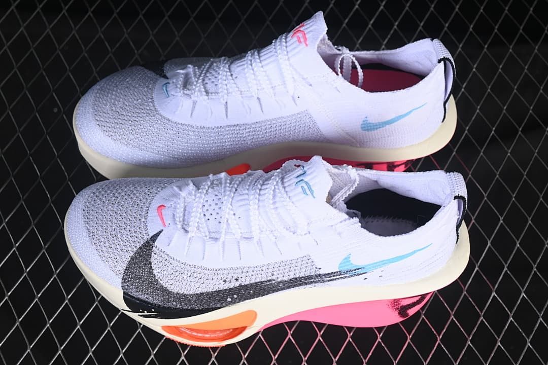 Pair of white running shoes shown from the side
