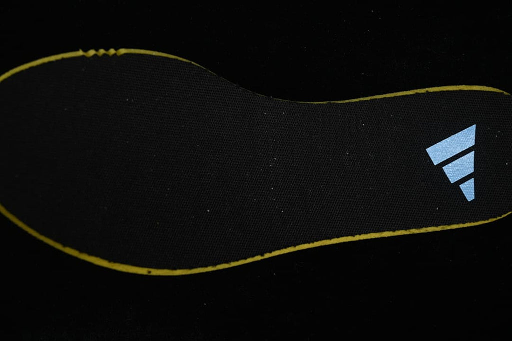 Black shoe insert with adidas logo and yellow edging