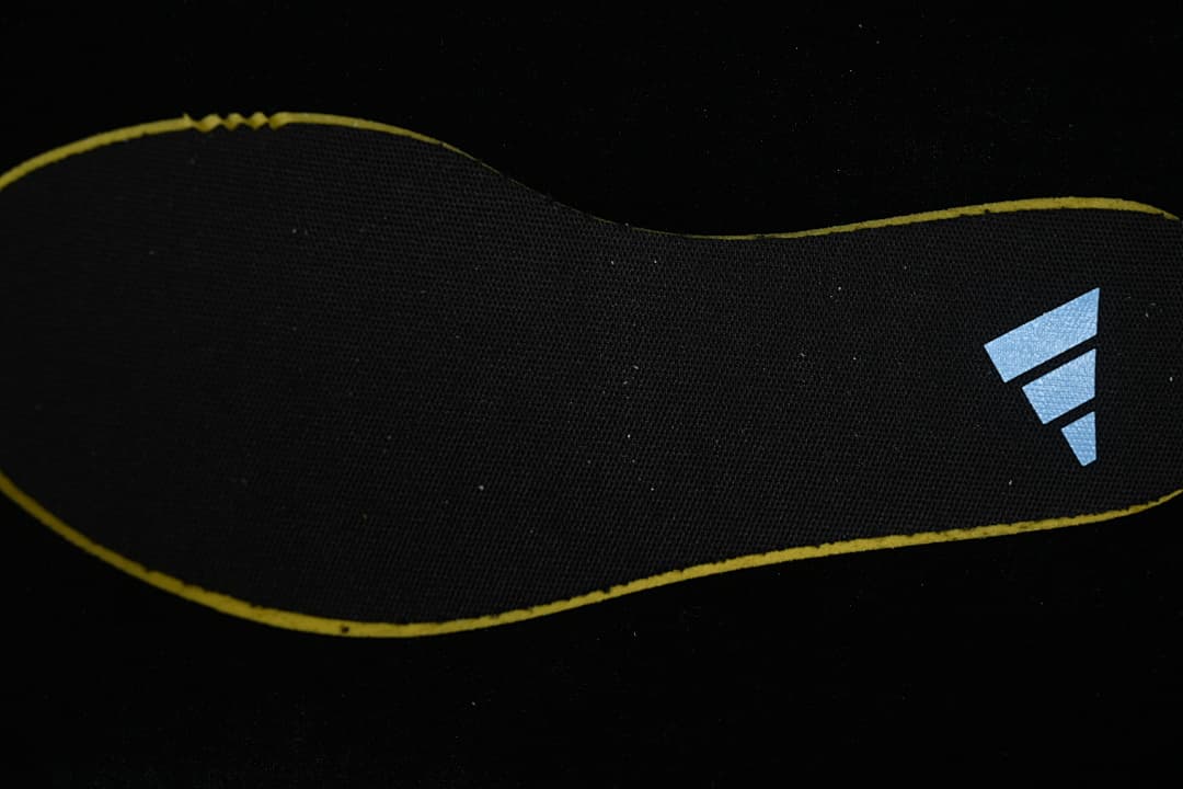 Black shoe insert with adidas logo and yellow edging