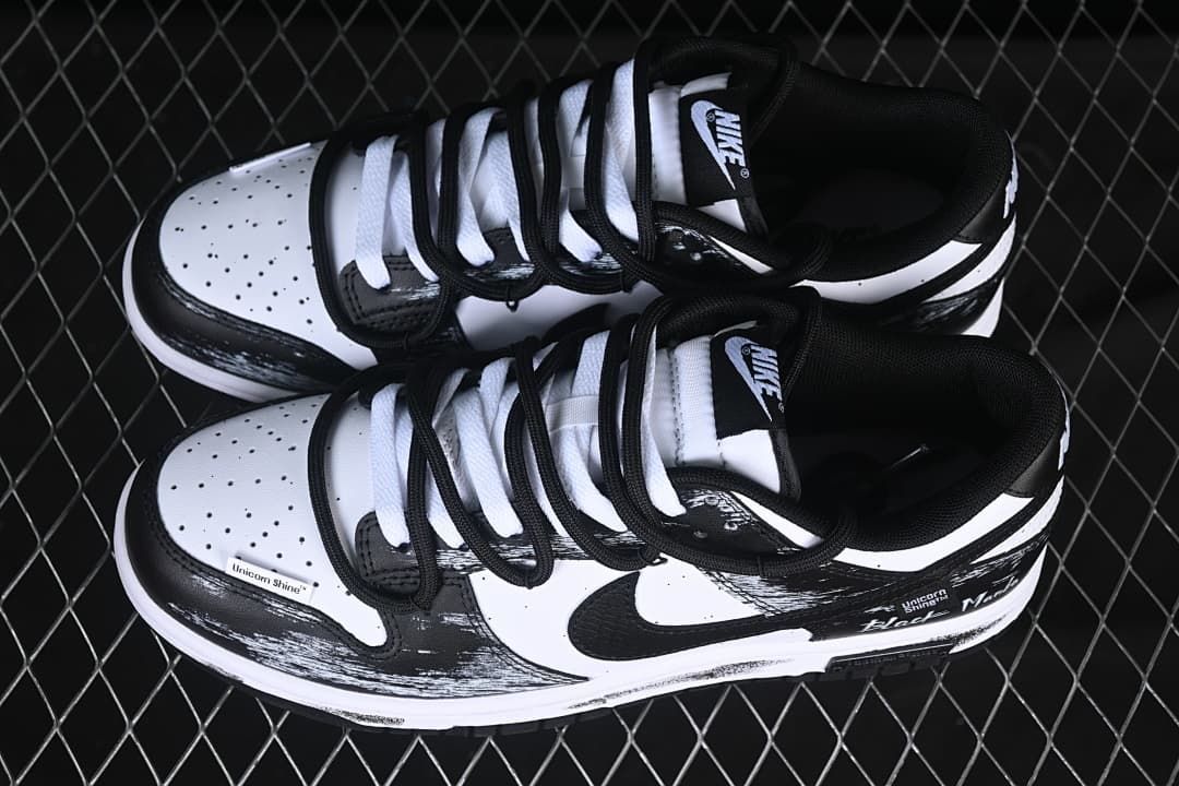 Pair of black and white low-top sneakers shown from above