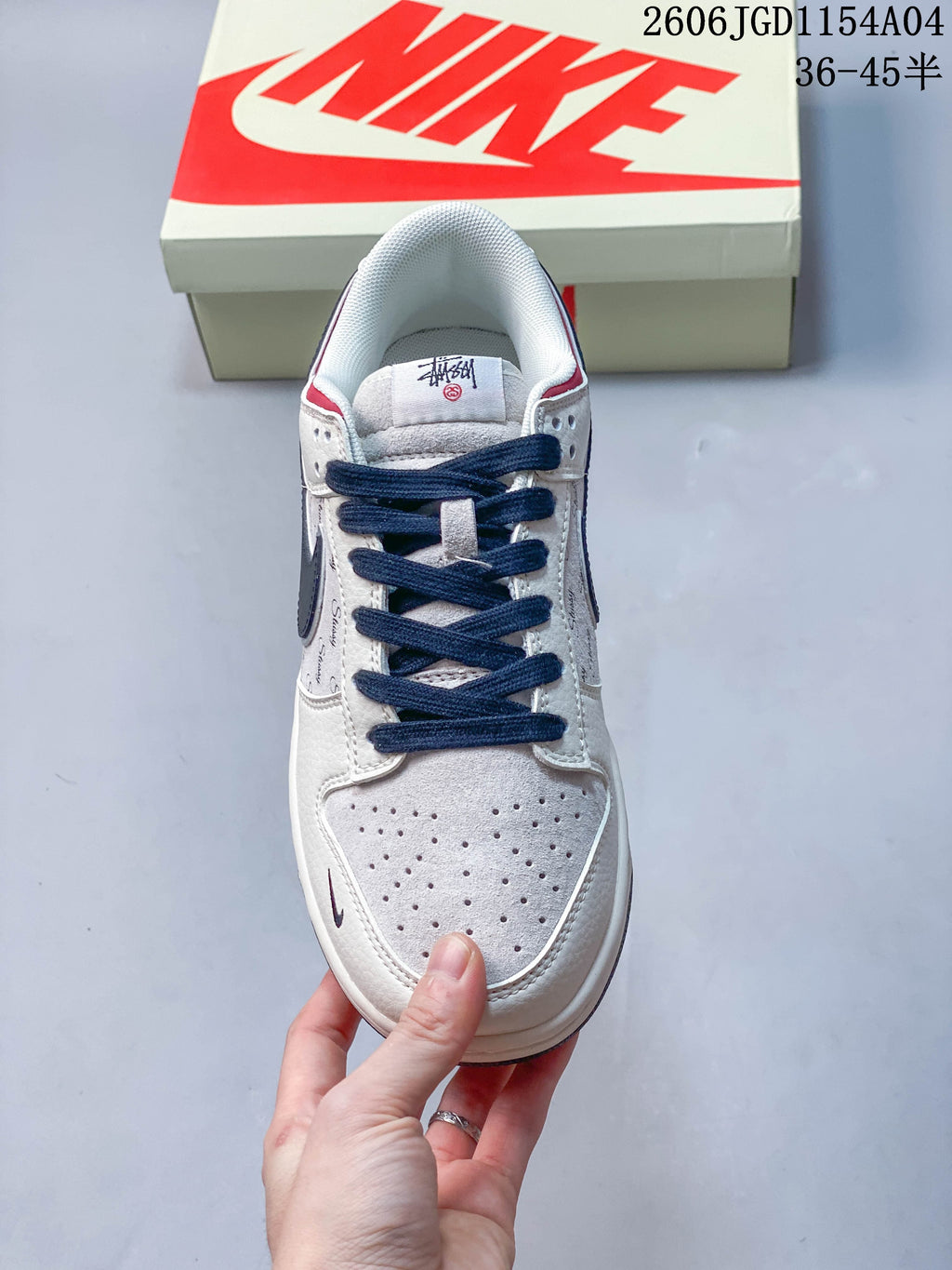 Top view of a Nike SB Dunk Low sneaker with navy laces and a perforated light-colored toe.