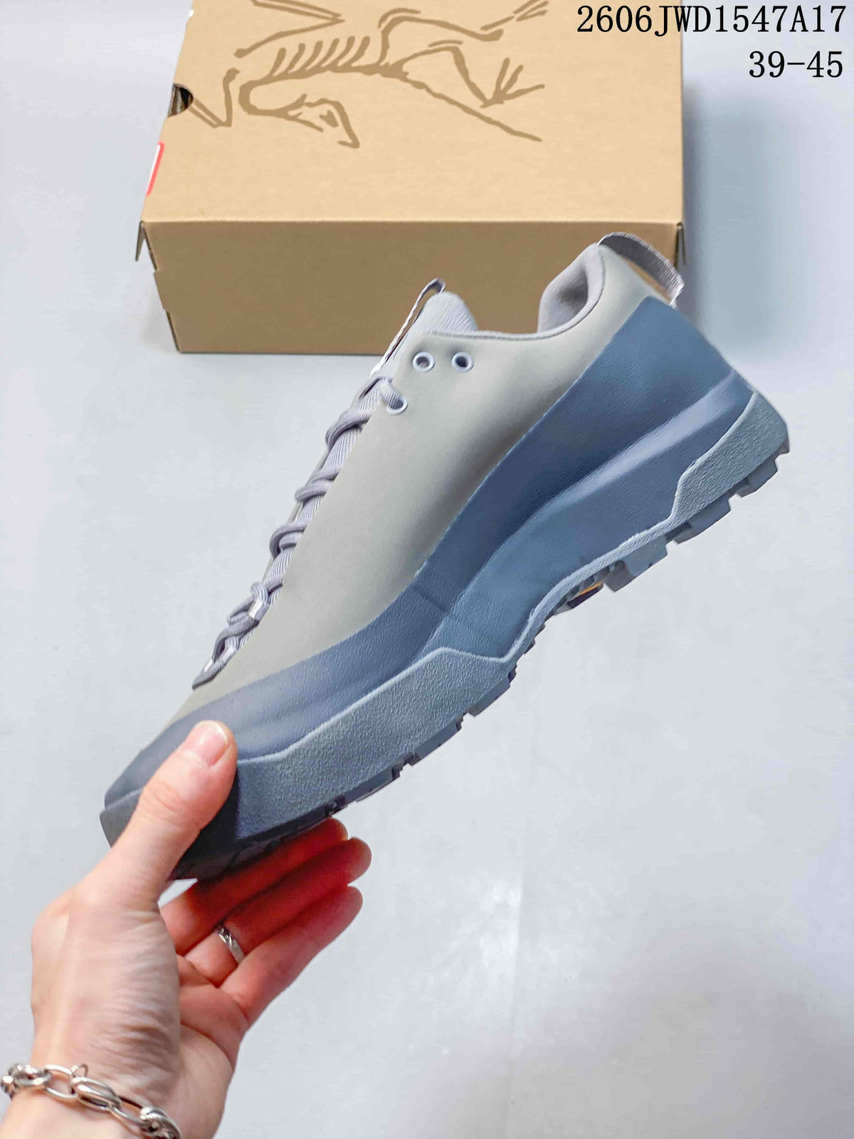Side view of a grey low-top shoe with a blue-grey midsole and outsole