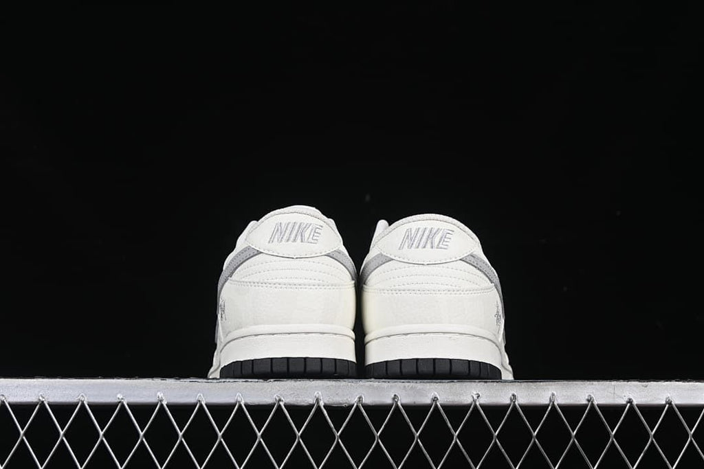 Rear view of both sneakers showing heel panels and black outsoles.