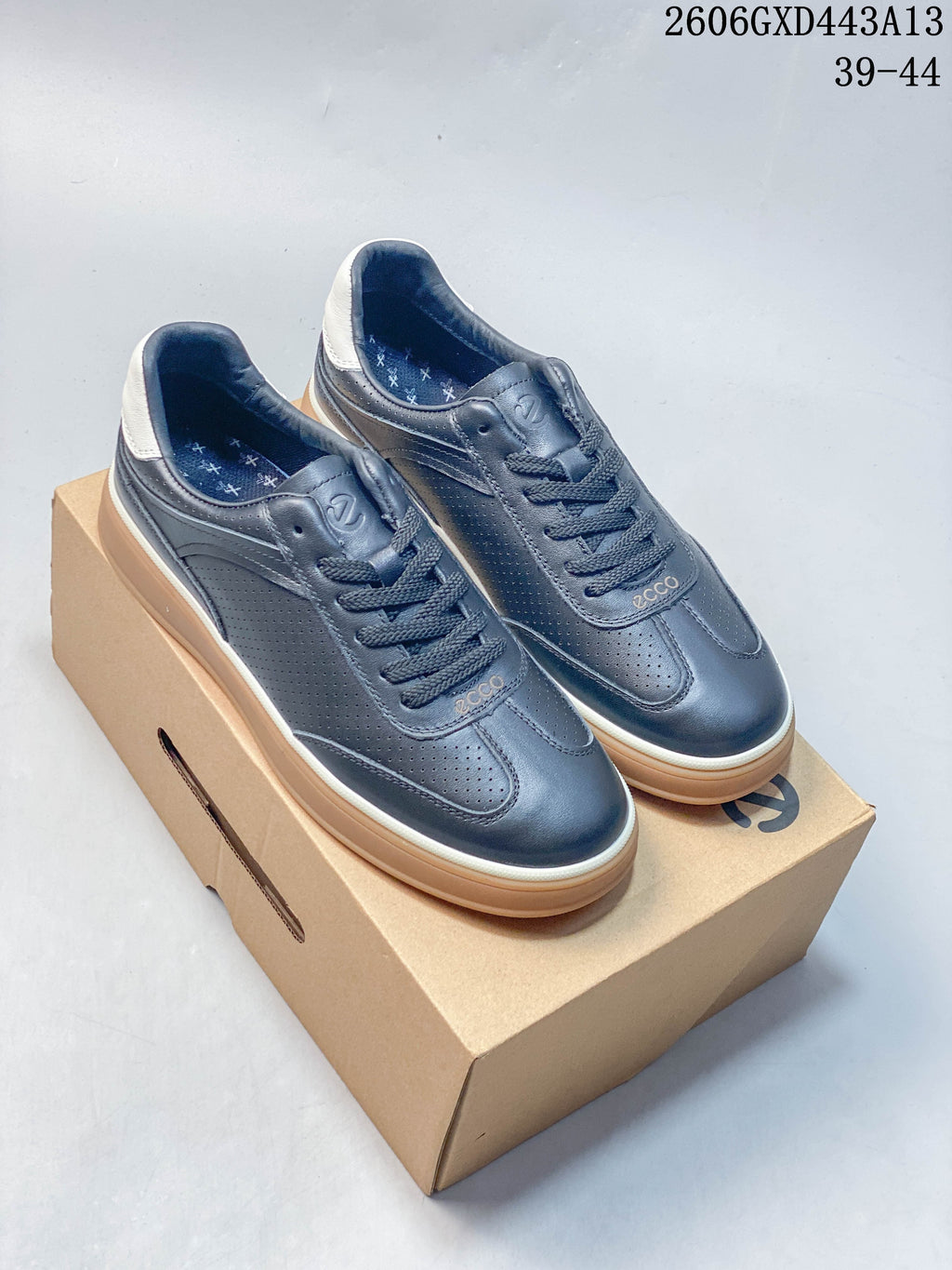 Pair of navy ECCO low-top sneakers with white heel accents and gum-colored soles