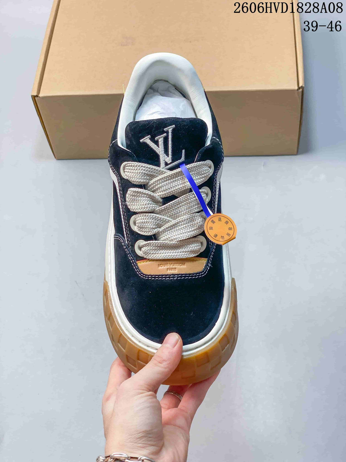 Top view of navy sneaker with cream laces and tongue logo