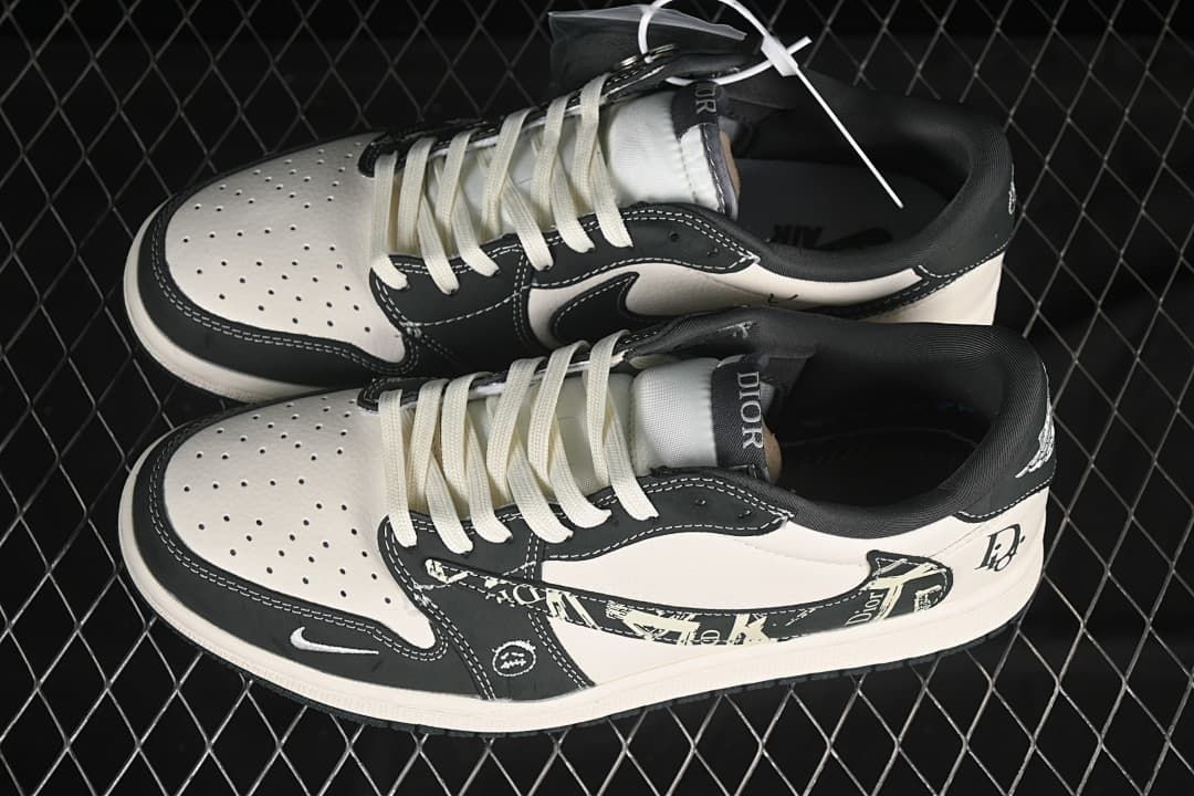 Overhead view of a pair of black-and-white low-top sneakers with patterned panels, perforated toes, and light laces.