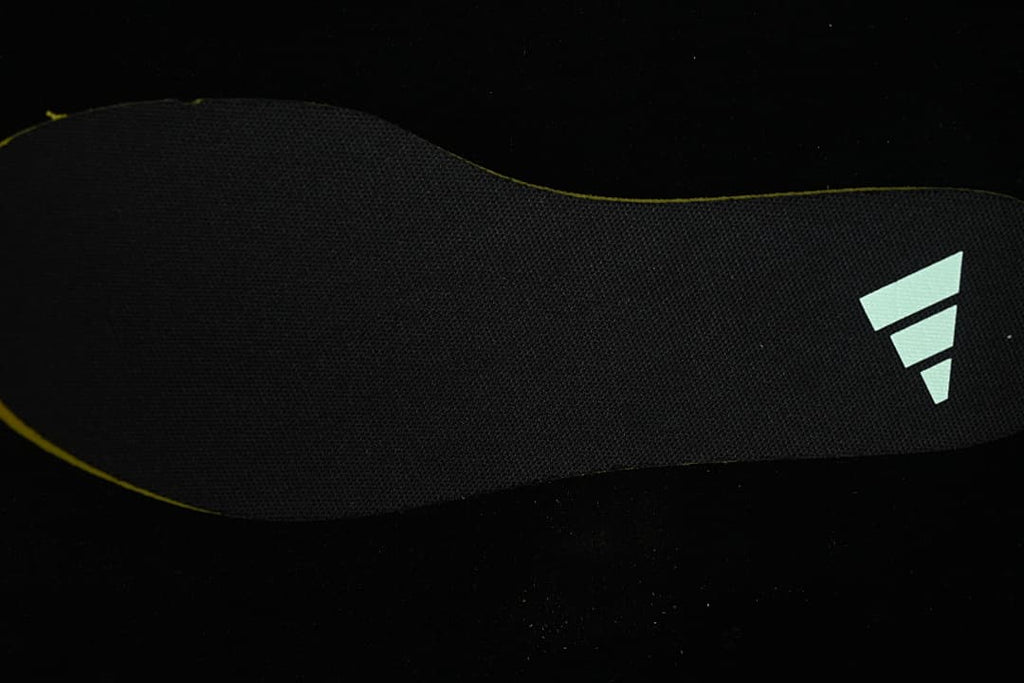 Black shoe insole with a pale Adidas logo