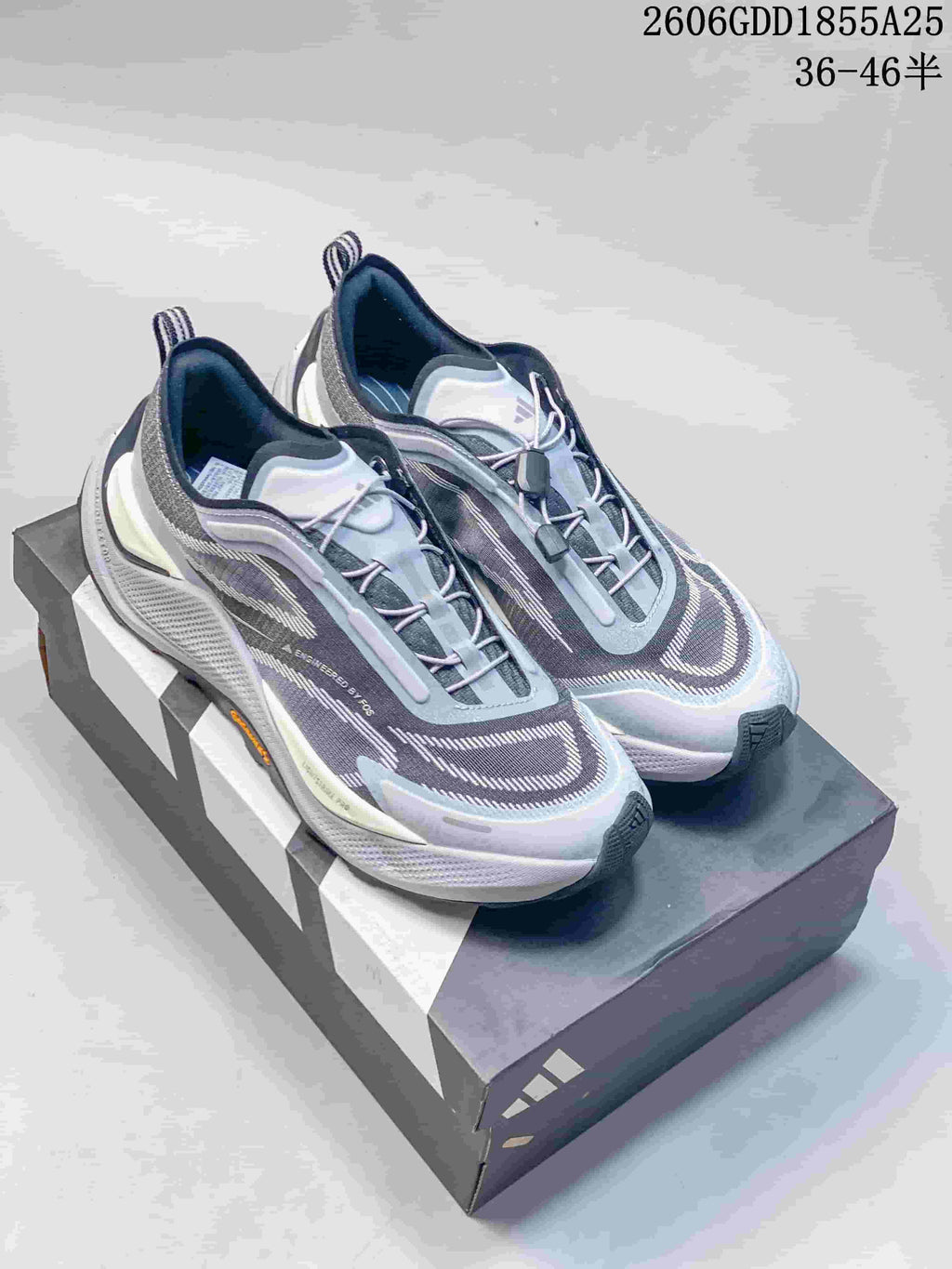 Gray and pale blue Adidas Holo Peak shoes displayed on a shoebox