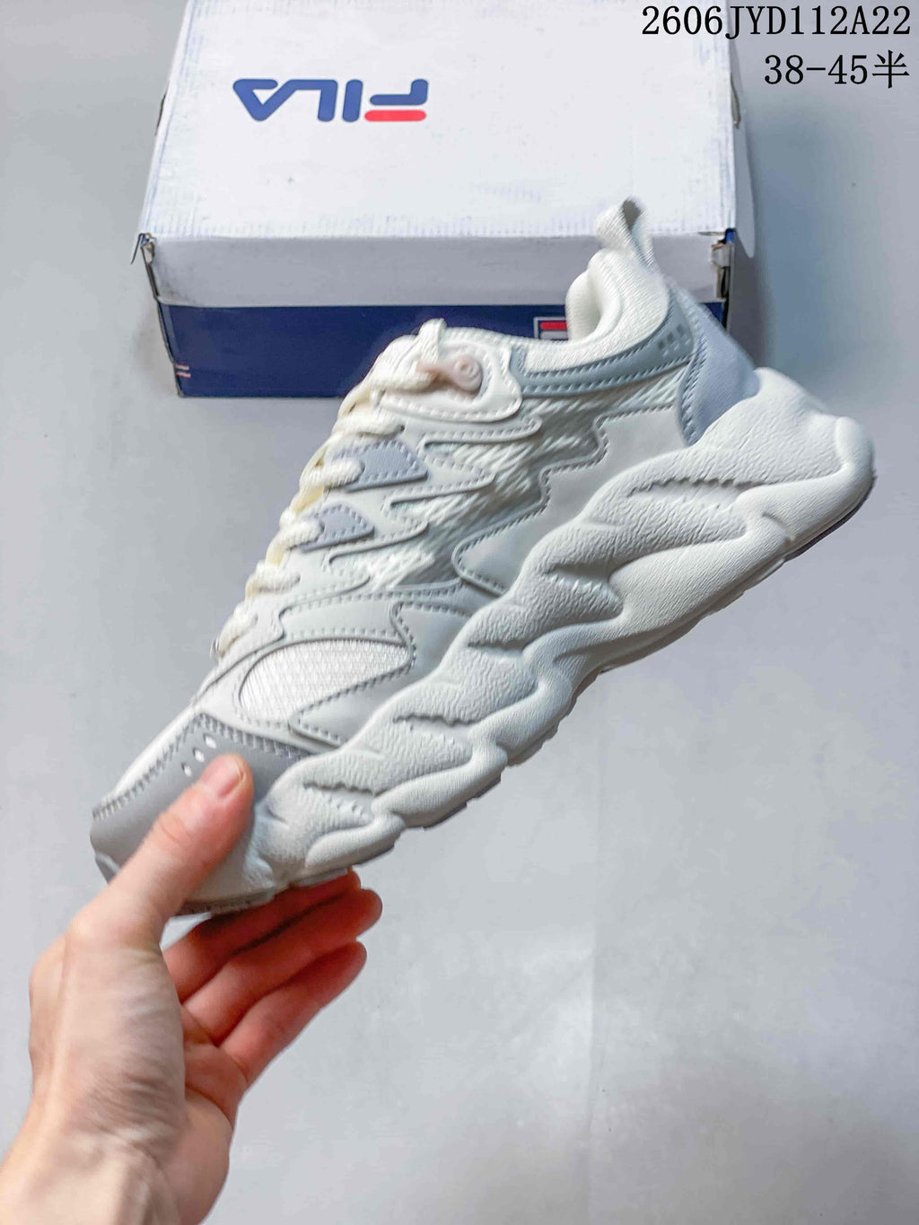 Side view of the white and gray FILA FUSION Arceus sneaker with a chunky sole