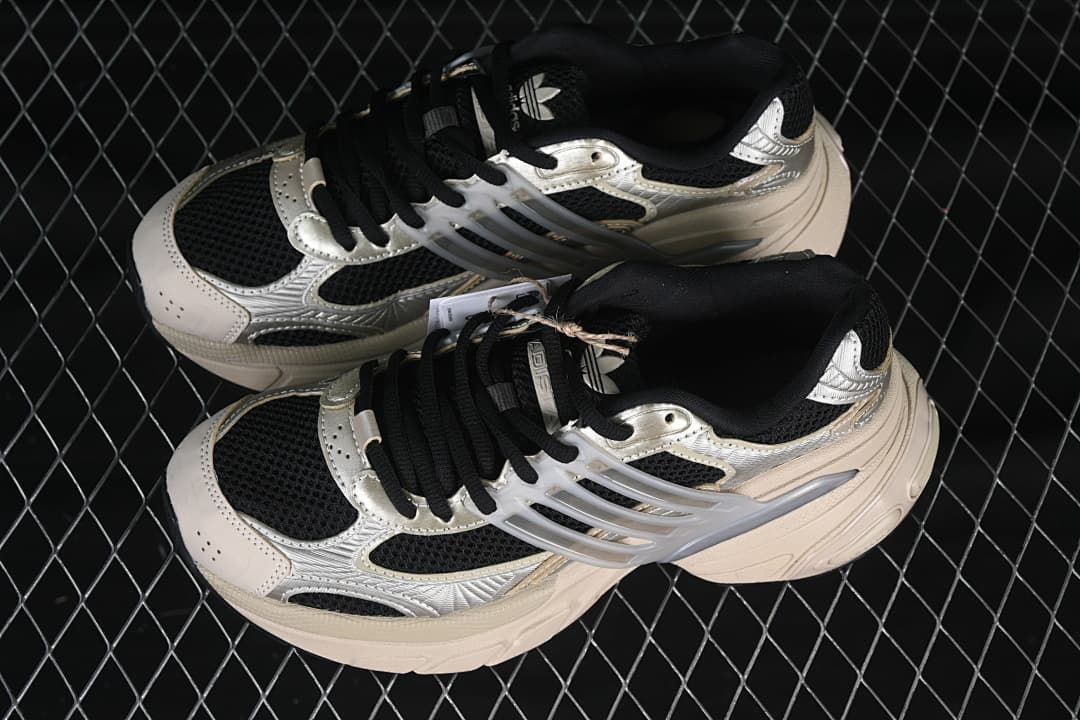 Pair of silver, beige and black sneakers viewed from above