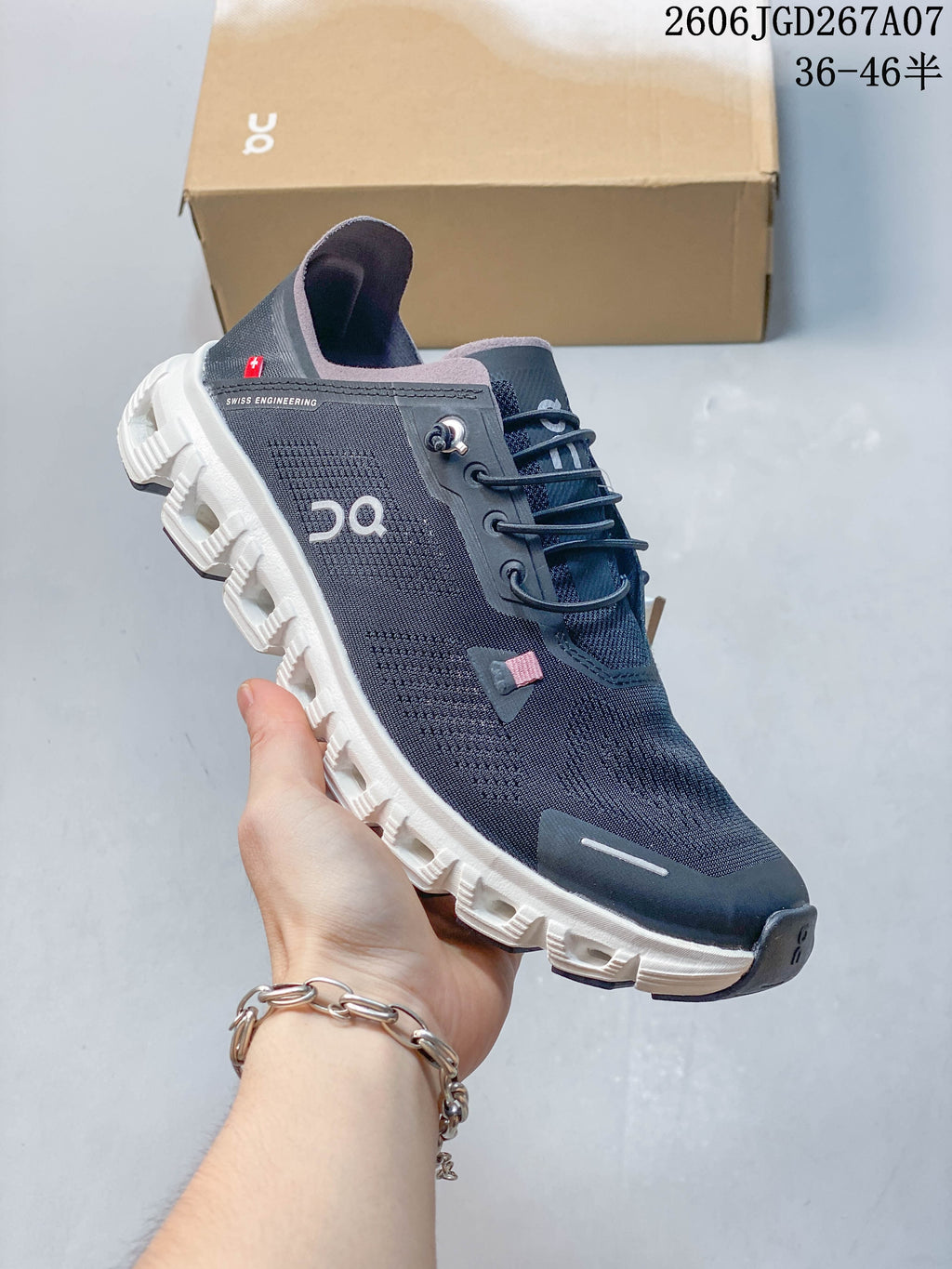 Angled side view highlighting the dark navy upper, heel pull tab, and white segmented sole.