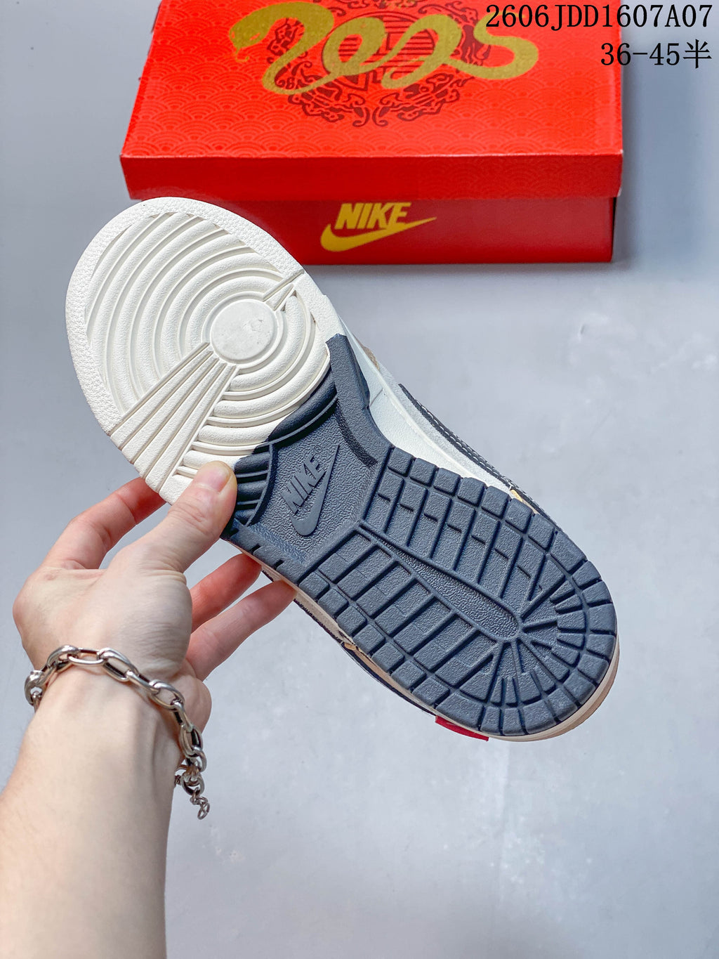 Underside of a Nike low-top sneaker showing a two-tone tread and a red box in the background; image overlay states sizes 36–45.5.