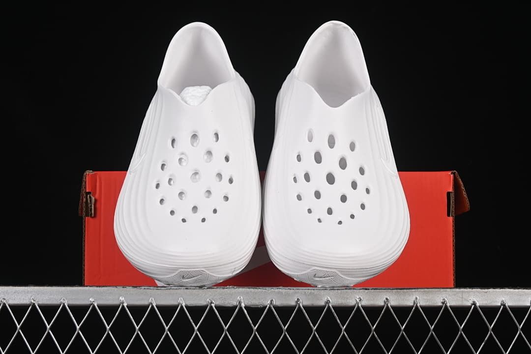 Pair of white clog slides shown from the front