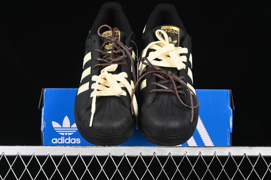 Front view of the pair showing textured black shell toes and cream stripes.