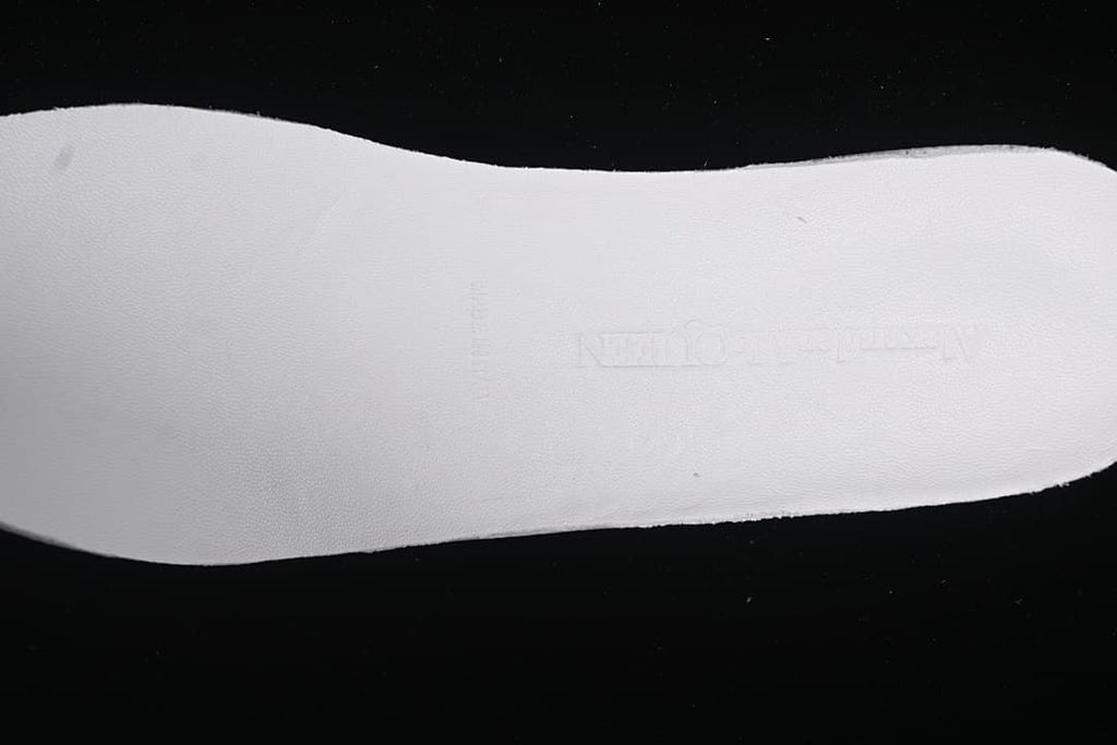 Close-up of the white sole sidewall with embossed branding.