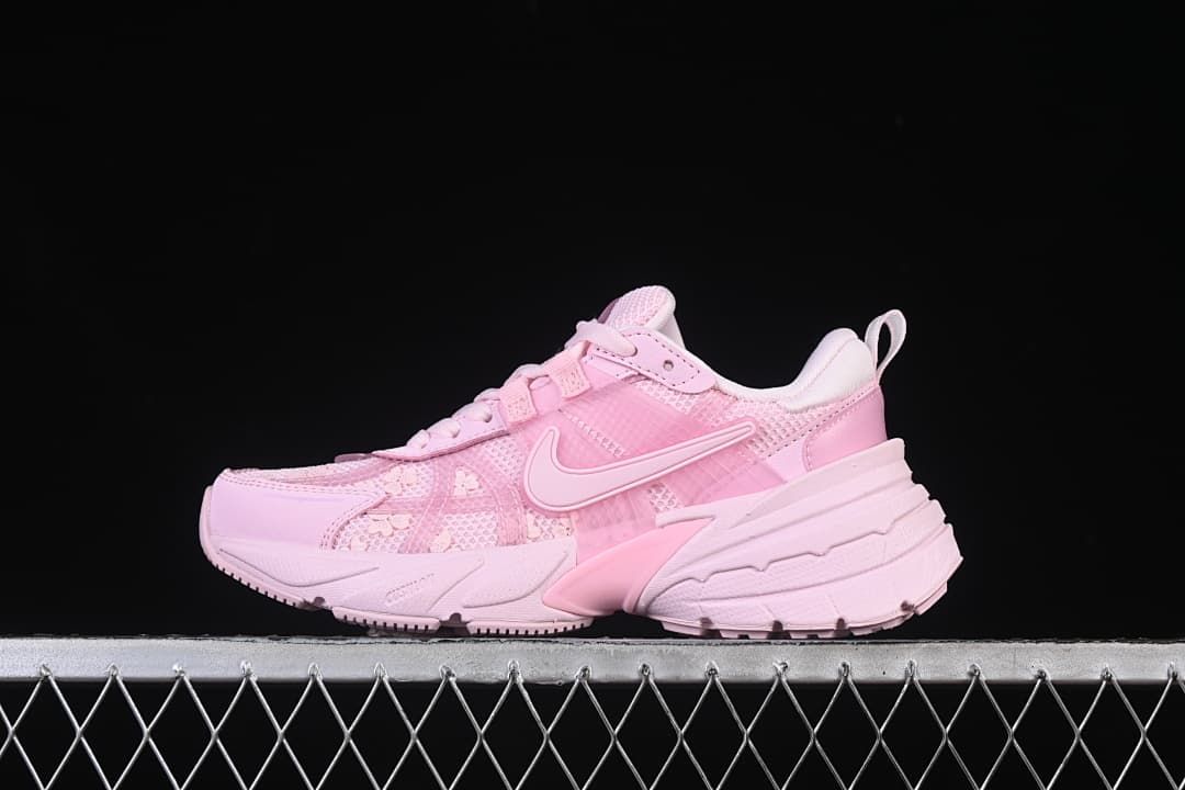 Side view of a pink Nike V2K Run sneaker with floral details