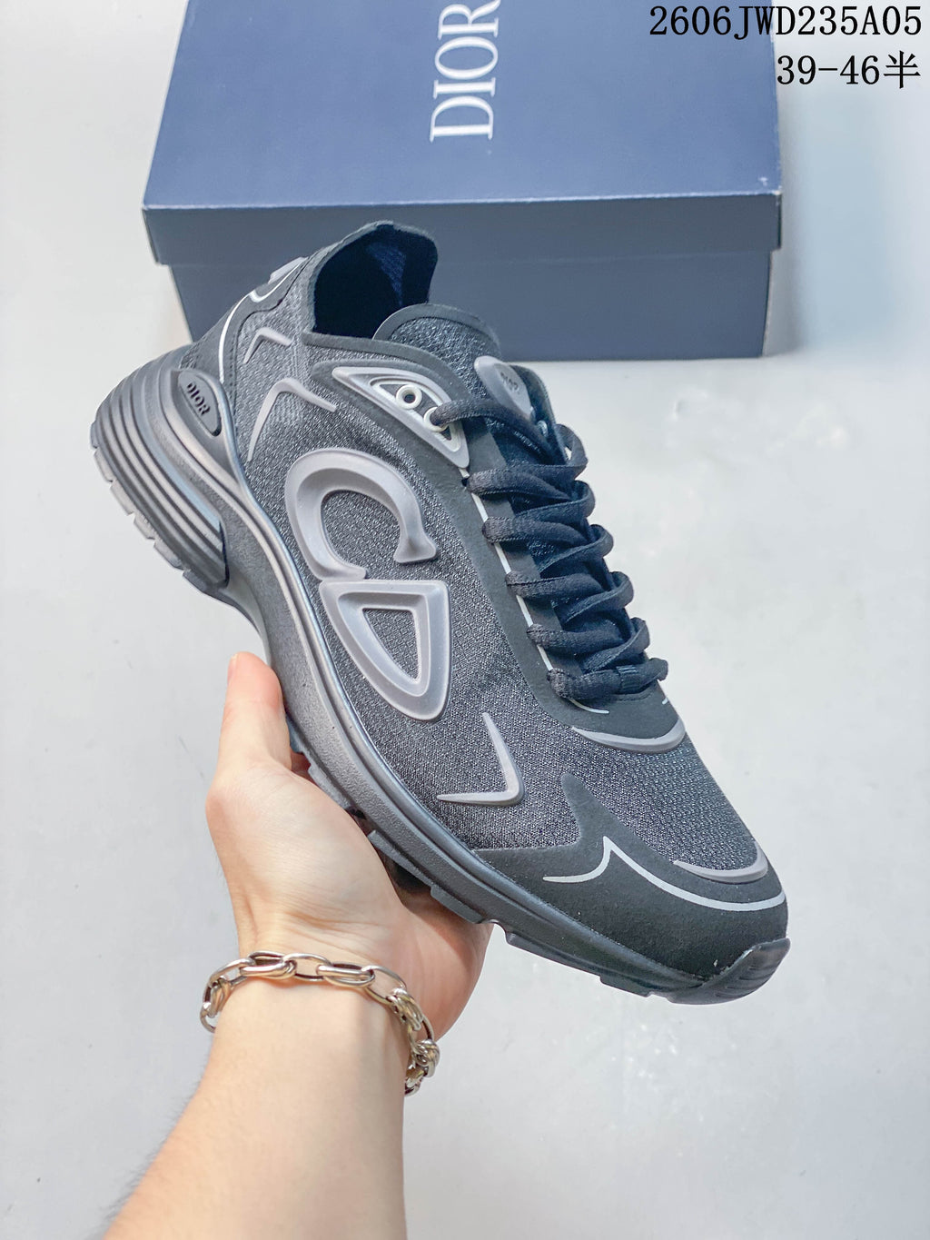 Angled side view of a grey Dior B30 sneaker with a lace-up front and raised side details.