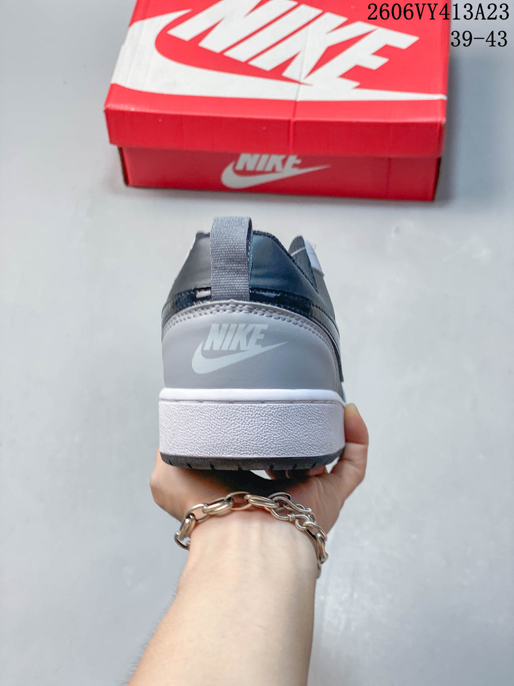 Rear view of a gray NikeCourt Borough 2 sneaker with a white midsole
